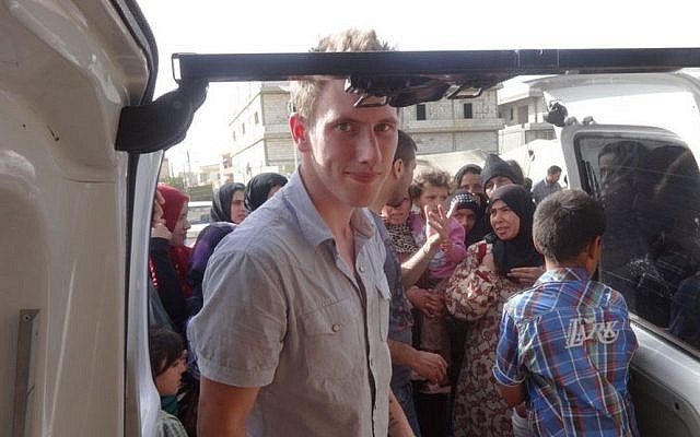 An undated photo shows Peter Kassig delivering supplies for Syrian refugees. (photo credit: AP/Courtesy Kassig Family) An undated photo shows Peter Kassig delivering supplies for Syrian refugees. (photo credit: AP/Courtesy Kassig Family)