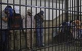 (Illustrative) Eight Egyptian men convicted for 'inciting debauchery' following their appearance in a video of an alleged same-sex wedding party on a Nile boat appear in the defendant's cage in a courtroom in Cairo, Egypt, Saturday, November 1, 2014 (Photo credit: Hassan Ammar/AP)