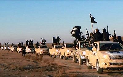 This file image posted on a militant website on Tuesday, Jan. 7, 2014, shows a convoy of vehicles and fighters from the Islamic State in Iraq's Anbar Province. (photo credit: AP Photo/militant website)