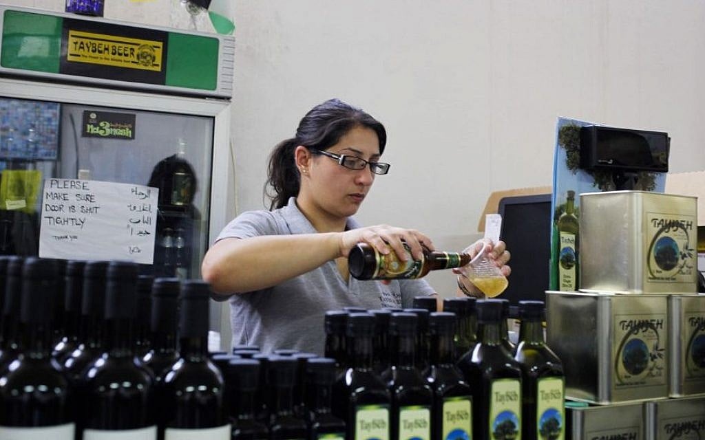 A woman works at the Palestinian Taybeh brewery in Taybeh, West Bank October 28, 2014 (Photo credit: Nasser Shiyoukhi/AP) A woman works at the Palestinian Taybeh brewery in Taybeh, West Bank October 28, 2014 (Photo credit: Nasser Shiyoukhi/AP)