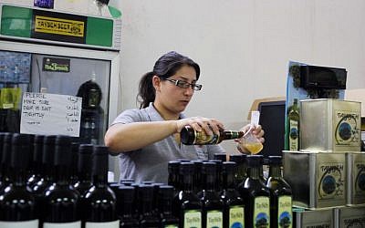 A woman works at the Palestinian Taybeh brewery in Taybeh, West Bank October 28, 2014 (Photo credit: Nasser Shiyoukhi/AP)