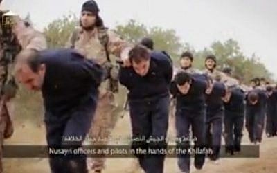 This still image taken from an undated video, published on the Internet by Islamic State terrorists on November 16, 2014, purports to show IS marching Syrian soldiers before beheading them. (photo credit: AP)