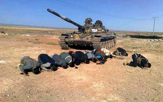 In this April 30, 2014, file image provided by the Syrian Revolution Against Bashar Assad, which has been authenticated based on its contents and other AP reporting, Syrian rebels pray in front of their tank at al Mutayia village in the southern province of Daraa, Syria. (AP/the Syrian Revolution Against Bashar Assad) In this April 30, 2014, file image provided by the Syrian Revolution Against Bashar Assad, which has been authenticated based on its contents and other AP reporting, Syrian rebels pray in front of their tank at al Mutayia village in the southern province of Daraa, Syria. (AP/the Syrian Revolution Against Bashar Assad)