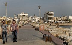 In this Tuesday, Oct. 28, 2014 photo, men stroll down a promenade in the Syrian coastal city of Tartous. (photo credit: AP/Diaa Hadid)