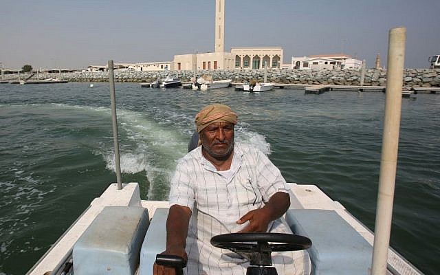 Emirati fisherman Rashid Salem Abdullah Binyim rides his boat off coast of Umm al-Quwain, United Arab Emirates. UAE’s late leader Sheik Zayed bin Sultan Al Nahyan patronized tribes and villages under his leadership by establishing an expansive welfare program that younger generations of Emiratis have come to expect. This gravy train has created a vast middle class of Emiratis who almost entirely rely on the government for jobs and benefits to maintain their standard of living. Monday, July 13, 2014 (photo credit: AP/Kamran Jebreili) Emirati fisherman Rashid Salem Abdullah Binyim rides his boat off coast of Umm al-Quwain, United Arab Emirates. UAE’s late leader Sheik Zayed bin Sultan Al Nahyan patronized tribes and villages under his leadership by establishing an expansive welfare program that younger generations of Emiratis have come to expect. This gravy train has created a vast middle class of Emiratis who almost entirely rely on the government for jobs and benefits to maintain their standard of living. Monday, July 13, 2014 (photo credit: AP/Kamran Jebreili)