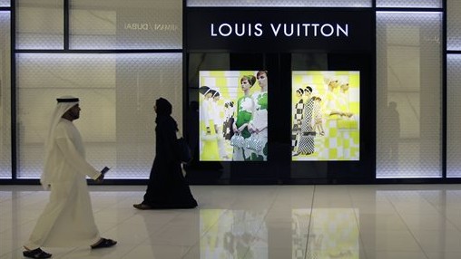 Emirati nationals pass by a "Louis Vuitton" fashion store at a shopping mall in Dubai, United Arab Emirates. Although the UAE is one of the wealthiest countries in the region, the gap between its richest families and everyone else is vast. Thursday, April 25, 2013 (Photo Credit: AP /Kamran Jebreili) Emirati nationals pass by a "Louis Vuitton" fashion store at a shopping mall in Dubai, United Arab Emirates. Although the UAE is one of the wealthiest countries in the region, the gap between its richest families and everyone else is vast. Thursday, April 25, 2013 (Photo Credit: AP /Kamran Jebreili)