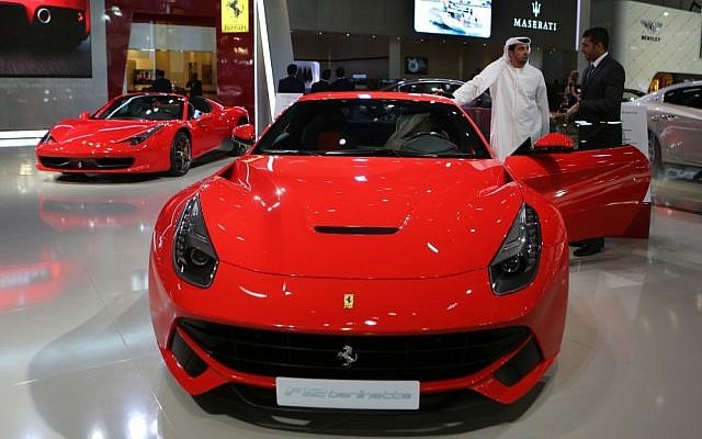 An Emirati visitor talks with a car agent dealer over the Ferrari F12 Berlinetta at the Dubai International Motor Show in Dubai, United Arab Emirates, April 25, 2013 (photo credit: AP/Kamran Jebreili) An Emirati visitor talks with a car agent dealer over the Ferrari F12 Berlinetta at the Dubai International Motor Show in Dubai, United Arab Emirates, April 25, 2013 (photo credit: AP/Kamran Jebreili)