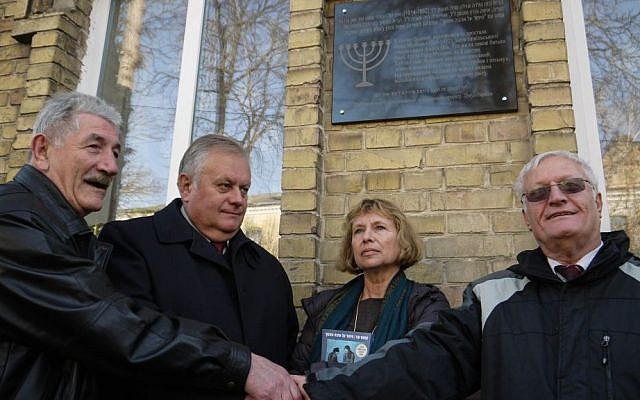 From left: Rivne Jewish community leader Gennady Frayerman, Rivne Mayor Volodymyr Khomko, Haifa University Professor Fania Oz-Salzberger and Limmud FSU co-founder Chaim Chesler shake hands after unveiling a plaque outside the house in which Oz-Salzberger's grandmother Fania Mussman, the mother of celebrated Israeli author Amos Oz, grew up, in Rivne, Ukraine, Monday, November 10, 2014( photo credit: Yifa Yaakov/The Times of Israel) From left: Rivne Jewish community leader Gennady Frayerman, Rivne Mayor Volodymyr Khomko, Haifa University Professor Fania Oz-Salzberger and Limmud FSU co-founder Chaim Chesler shake hands after unveiling a plaque outside the house in which Oz-Salzberger's grandmother Fania Mussman, the mother of celebrated Israeli author Amos Oz, grew up, in Rivne, Ukraine, Monday, November 10, 2014( photo credit: Yifa Yaakov/The Times of Israel)