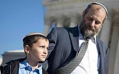 Ari Zivotofsky (right), stands with his nine-year-old son, Menachem, outside the Supreme Court in Washington, DC,  November 7, 2011. (photo credit: AP/Evan Vucci, File)