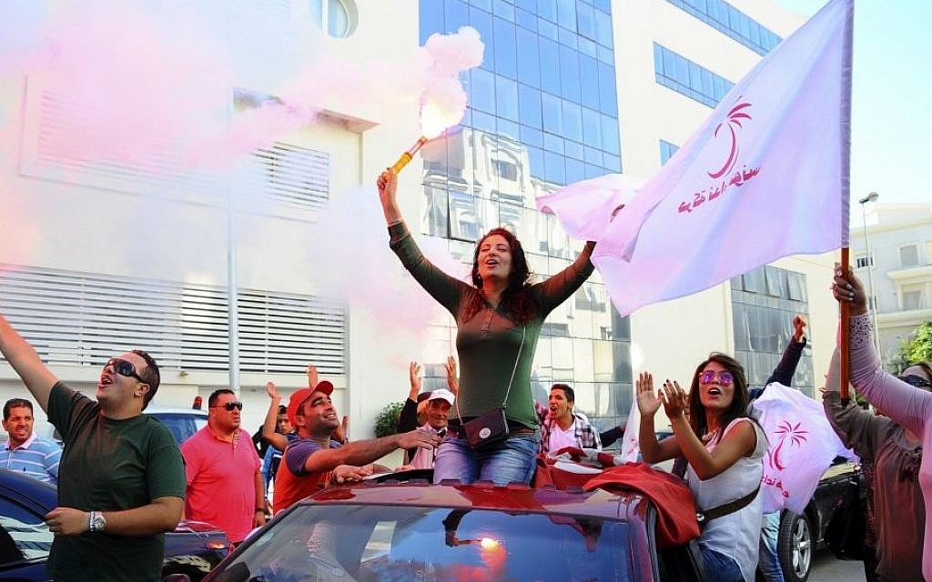 Supporters of Tunisian party Nida Tunis (Tunisia Calls) celebrate their victory in parliamentary elections in Tunis, October 28, 2014. (photo credit: AP/Hassene Dridi) Supporters of Tunisian party Nida Tunis (Tunisia Calls) celebrate their victory in parliamentary elections in Tunis, October 28, 2014. (photo credit: AP/Hassene Dridi)