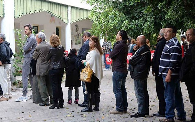 People line up outside a polling station to cast their vote during the first round of the Tunisian presidential election in Tunis, November 23, 2014. (photo credit: AP/Mohamed Wertani) People line up outside a polling station to cast their vote during the first round of the Tunisian presidential election in Tunis, November 23, 2014. (photo credit: AP/Mohamed Wertani)