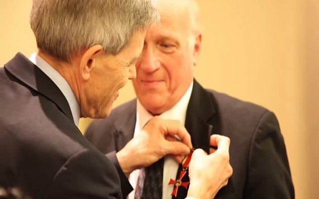 Cantor Benjamin Maissner receives the Order of the Merit of the Federal Republic of Germany from German Consul General Walter Stechel. (YouTube screenshot)