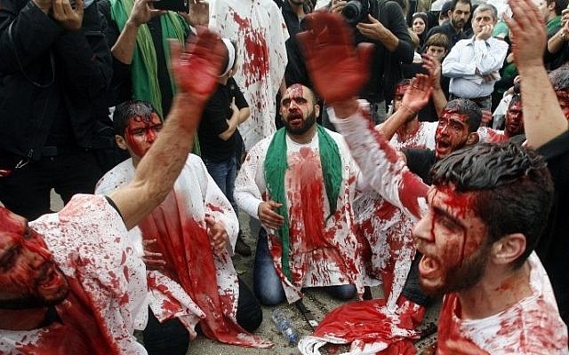 Lebanese Shiite Muslims take part in a self-flagellation procession during the Ashura commemorations that mark the killing of Imam Hussein -one of Shiite Islam's most revered figures- on November 4, 2014 in the southern Lebanese city of Nabatiyeh. (photo credit: AFP PHOTO / MAHMOUD ZAYYAT) Lebanese Shiite Muslims take part in a self-flagellation procession during the Ashura commemorations that mark the killing of Imam Hussein -one of Shiite Islam's most revered figures- on November 4, 2014 in the southern Lebanese city of Nabatiyeh. (photo credit: AFP PHOTO / MAHMOUD ZAYYAT)