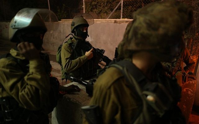 Israeli soldiers seen at the entrance to the Palestinian village of al-Aroub in the West Bank, where three Israeli soldiers were injured when a Palestinian driver rammed his car into them, close to the Gush Etzion Junction, November 5, 2014. (photo credit: Nati Shohat/Flash90) Israeli soldiers seen at the entrance to the Palestinian village of al-Aroub in the West Bank, where three Israeli soldiers were injured when a Palestinian driver rammed his car into them, close to the Gush Etzion Junction, November 5, 2014. (photo credit: Nati Shohat/Flash90)