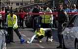 Israeli security personnel at the site where a Palestinian man stabbed an Israeli soldier multiple times in a terror attack at Tel Aviv’s Hahagana train station, November 10, 2014. (photo credit: Amir Levy/Flash90)
