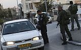 Israeli border police check the ID's of Arab-Israelis outside the East Jerusalem neighborhood of Jabel Mukaber on November 19, 2014. Photo credit: Nati Shohat/FLASH90)