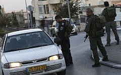 Israeli border police check the ID's of Arab-Israelis outside the East Jerusalem neighborhood of Jabel Mukaber on November 19, 2014. Photo credit: Nati Shohat/FLASH90)