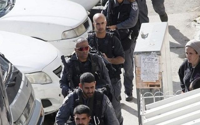 Security forces secure the scene on November 18, 2014, after two Palestinians attacked a synagogue in the ultra-Orthodox Har Nof neighborhood in Jerusalem. (photo credit: AFP PHOTO / GALI TIBBON) Security forces secure the scene on November 18, 2014, after two Palestinians attacked a synagogue in the ultra-Orthodox Har Nof neighborhood in Jerusalem. (photo credit: AFP PHOTO / GALI TIBBON)