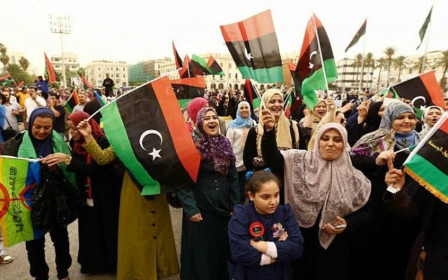 Libyans wave the national flag in a square in Tripoli, November 6, 2014 (photo credit: Mahmud Turkia/ AFP)
