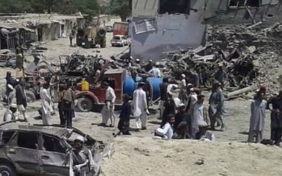 Afghanis survey the damage of a suicide bombing at a market in Paktika province in the country's east on July 15, 2014. (screen capture: YouTube)