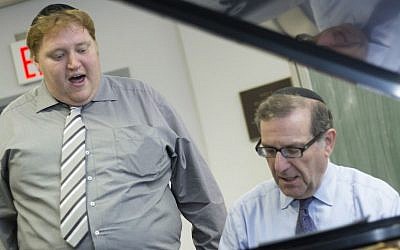 David Schwezoff, left, the recently elected leader of the Budapest Jewish community, singing with accompaniment by Cantor Bernard Beer in New York last year. (David Khabinsky/ via JTA)