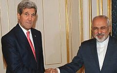 US Secretary of State John Kerry (left) and Iranian Foreign Minister Mohammad Javad Zarif shake hands prior to a bilateral meeting in Vienna, on November 23, 2014. (photo credit: AFP/Pool/Ronald Zak)
