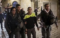 Police escort an Arab youth suspected of stabbing a Jewish man in Jerusalem's Old City on November 24, 2014 (photo credit: Yonatan Sindel/Flash90)