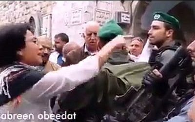 MK Hanin Zoabi (Balad) confront police outside the Tempe Mount, November, 5th, 2014.  (screen capture: YouTube/0404 news)