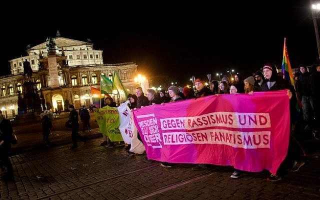 Demonstrators protest againts the Pegida movement, "Patriotische Europaeer Gegen die Islamisierung des Abendlandes," which translates to "Patriotic Europeans Against the Islamification of the Occident," rally on December 8, 2014 in Dresden, Germany (Photo credit: Arno Burgi/DPA/AFP) Demonstrators protest againts the Pegida movement, "Patriotische Europaeer Gegen die Islamisierung des Abendlandes," which translates to "Patriotic Europeans Against the Islamification of the Occident," rally on December 8, 2014 in Dresden, Germany (Photo credit: Arno Burgi/DPA/AFP)