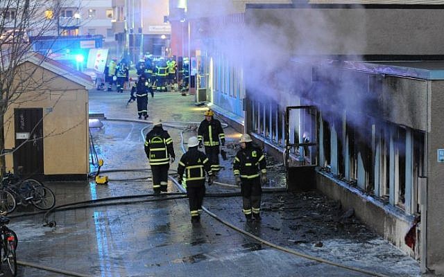 Smoke rises from the interior of a destroyed cellar mosque as firefighters walk in front of the building after an arson attack on December 25, 2014 in Eskilstuna, central Sweden. An arsonist set fire to the mosque in central Sweden on Thursday injuring five, police said, as the country faces a deep political crisis caused by the rise of the extreme right. (AFP/ TT News Agency /Pontus Stenberg) Smoke rises from the interior of a destroyed cellar mosque as firefighters walk in front of the building after an arson attack on December 25, 2014 in Eskilstuna, central Sweden. An arsonist set fire to the mosque in central Sweden on Thursday injuring five, police said, as the country faces a deep political crisis caused by the rise of the extreme right. (AFP/ TT News Agency /Pontus Stenberg)