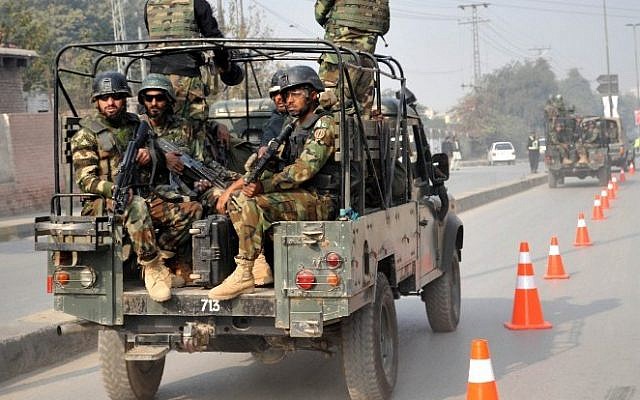 Pakistani troops reach the site of an attack by Taliban gunmen on a school in Peshawar on December 16, 2014.  (photo credit: AFP/A MAJEED)