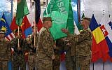 US General John Campbell (4L) lowers the flag of the NATO-led International Security Assistance Force (ISAF) during a ceremony marking the end of ISAF's combat mission in Afghanistan at ISAF headquarters in Kabul on December 28, 2014. (photo credit: AFP/ SHAH Marai)