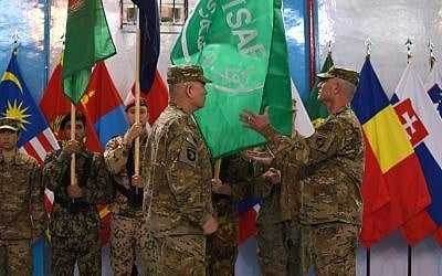 US General John Campbell (4L) lowers the flag of the NATO-led International Security Assistance Force (ISAF) during a ceremony marking the end of ISAF's combat mission in Afghanistan at ISAF headquarters in Kabul on December 28, 2014. (photo credit: AFP/ SHAH Marai)