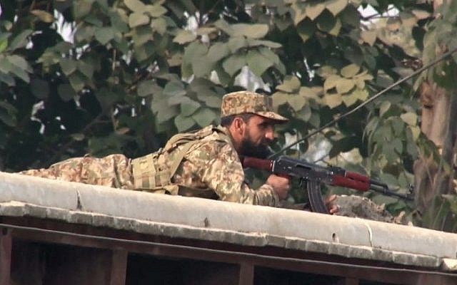 A Pakistani soldier taking up a position following an attack on a school by Taliban gunmen in Peshawar on December 16, 2014. (photo credit: AFP/Aftab Ahmed)