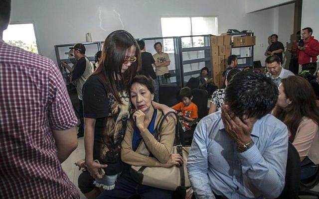 Family members of passengers of missing Malaysian air carrier AirAsia flight QZ8501 gather at Juanda international airport in Surabaya in East Java on December 28, 2014 hours after the news the flight went missing. (photo credit: AFP/Juni KRISWANTO) Family members of passengers of missing Malaysian air carrier AirAsia flight QZ8501 gather at Juanda international airport in Surabaya in East Java on December 28, 2014 hours after the news the flight went missing. (photo credit: AFP/Juni KRISWANTO)