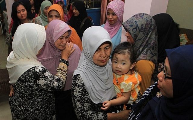 Rohana, the mother of Khairunisa, a flight attendant who was traveling on missing Air Asia Flight QZ 8501, and relatives gather at their home in Palembang, South Sumatra, on December 28, 2014. (photo credit: AFP PHOTO / Abdul Qodir) Rohana, the mother of Khairunisa, a flight attendant who was traveling on missing Air Asia Flight QZ 8501, and relatives gather at their home in Palembang, South Sumatra, on December 28, 2014. (photo credit: AFP PHOTO / Abdul Qodir)