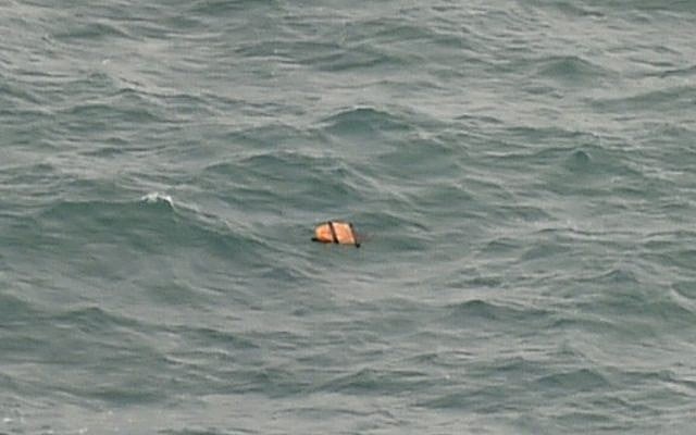 This aerial view taken from an Indonesian search and rescue aircraft over the Java Sea shows floating debris spotted in the same area as other items being investigated by Indonesian authorities as possible objects from missing AirAsia flight QZ8501 on December 30, 2014. (photo credit: AFP/Bay ISMOYO)