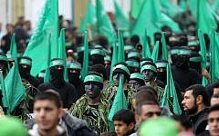 Palestinian members of the Izz ad-Din al-Qassam Brigades, the armed wing of Hamas, at a rally to commemorate the 27th anniversary of the Islamist movement’s creation, at the Nuseirat refugee camp in the Gaza Strip, on December 12, 2014. (AFP/Said Khatib)