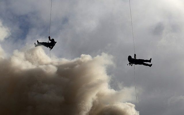 Members of the al-Qassam Brigades, Hamas's armed wing, show rappelling skills during a parade marking the 27th anniversary of the Islamist movement’s creation on December 14, 2014 in Gaza City. (photo credit: AFP/MAHMUD HAMS)