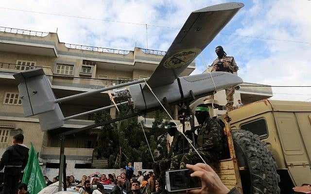 Members of the al-Qassam Brigades, Hamas's armed wing, display a drone during a parade marking the 27th anniversary of the Islamist movement’s creation on December 14, 2014 in Gaza City. (AFP/Mahmud Hams)