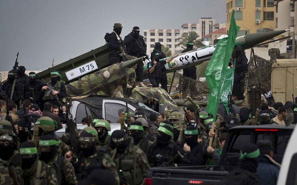 Members of the al-Qassam Brigades, Hamas's armed wing, display weapons during a parade marking the 27th anniversary of the Islamist movement’s creation on December 14, 2014 in Gaza City. (photo credit: AFP/MAHMUD HAMS)