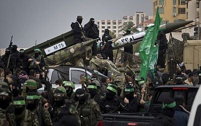 Members of the al-Qassam Brigades, Hamas's armed wing, display weapons during a parade marking the 27th anniversary of the Islamist movement’s creation on December 14, 2014 in Gaza City. (photo credit: AFP/MAHMUD HAMS)