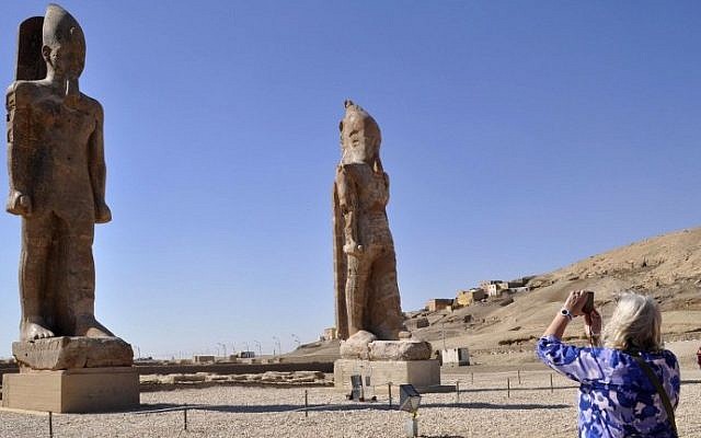 Illustrative: A tourist takes a picture of two colossal statues of Pharaoh Amenhotep III in Egypt's famed temple city of Luxor, December 14, 2014. (photo credit: AFP/Radwan Abu Elmagd) Illustrative: A tourist takes a picture of two colossal statues of Pharaoh Amenhotep III in Egypt's famed temple city of Luxor, December 14, 2014. (photo credit: AFP/Radwan Abu Elmagd)
