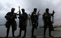 Palestinian divers from the al-Qassam Brigades, Hamas' armed wing, take part in a parade marking the 27th anniversary of the Islamist movement’s creation on December 14, 2014 in Gaza City. (photo credit: AFP/ MAHMUD HAMS)