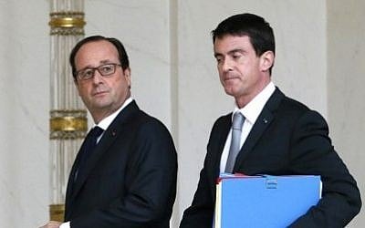 French President François Hollande (L) and French Prime Minister Manuel Valls leave the Elysee Palace after the weekly cabinet meeting on December 22, 2014 in Paris. (photo credit: AFP PHOTO / PATRICK KOVARIK)