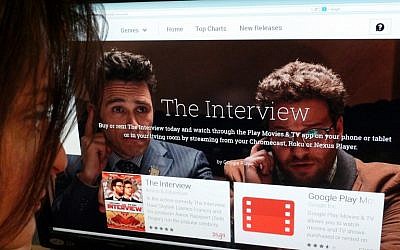 In this December 24, 2014 photo illustration a woman looks at the Google Play purchase page for the Sony film "The Interview," in Washington, DC. (photo credit: AFP PHOTO / STF)