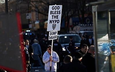 An anti-Mayor Bill de Blasio protester holds up a sign outside of Christ Tabernacle Church for the funeral of slain New York City Police Officer Rafael Ramos, one of two officers murdered while sitting in their patrol car in an ambush in Brooklyn last Saturday afternoon, on December 27, 2014 in New York City (photo credit: Spencer Platt/Getty Images/AFP) An anti-Mayor Bill de Blasio protester holds up a sign outside of Christ Tabernacle Church for the funeral of slain New York City Police Officer Rafael Ramos, one of two officers murdered while sitting in their patrol car in an ambush in Brooklyn last Saturday afternoon, on December 27, 2014 in New York City (photo credit: Spencer Platt/Getty Images/AFP)