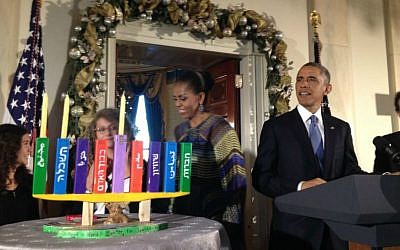 President Obama, First Lady Michelle Obama and students from the Max Rayne Hand in Hand School with the Hanukkah menorah made by the school's classes and lighted at the White House Hanukkah party, December 17, 2014. (photo credit: Carole Zawatsky)