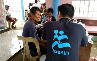 IsraAid volunteers offering medical aid in the Philippines after Typhoon Hagupit wreaked havoc, on December 22, 2014. (photo credit: Courtesy IsraAid)