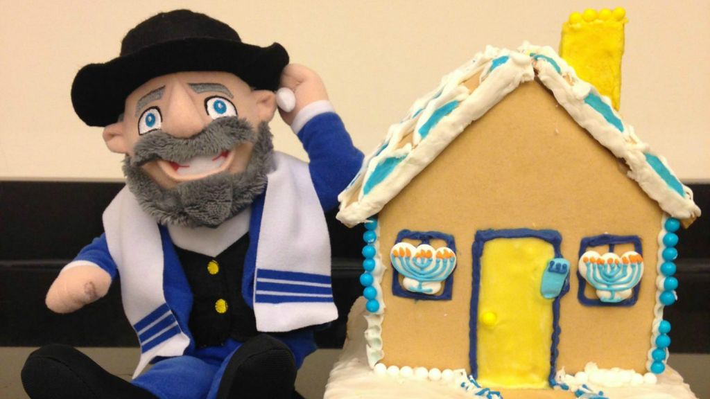 Mensch on the Bench next to an edible Hanukkah House. (courtesy) Mensch on the Bench next to an edible Hanukkah House. (courtesy)